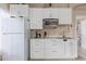 Well-lit kitchen featuring white cabinets, modern appliances, and lots of natural light at 17128 E Kensington Pl, Fountain Hills, AZ 85268