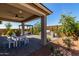 Covered patio with an outdoor kitchen, dining area, pergola and seating area at 17656 W Bajada Rd, Surprise, AZ 85387