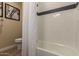 Bright bathroom features a shower-tub combo with white subway tile and decorative accent border at 17656 W Bajada Rd, Surprise, AZ 85387