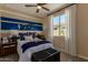 Nicely decorated bedroom with a nautical themed wall, a ceiling fan, and a window for natural light at 17656 W Bajada Rd, Surprise, AZ 85387
