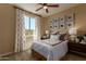 Comfortable bedroom with carpet, a ceiling fan, a window, and a nicely decorated wall at 17656 W Bajada Rd, Surprise, AZ 85387