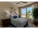 Cozy bedroom with a blue and white bedspread, a window for natural light, and a ceiling fan at 17656 W Bajada Rd, Surprise, AZ 85387
