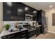 Contemporary kitchen with stainless steel appliances and sleek black cabinetry at 17656 W Bajada Rd, Surprise, AZ 85387