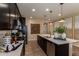 Gourmet kitchen with a center island, stainless appliances, and sleek dark cabinetry at 17656 W Bajada Rd, Surprise, AZ 85387
