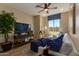 Cozy living room featuring wood-look tile flooring and lots of natural light at 17656 W Bajada Rd, Surprise, AZ 85387