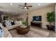 Bright living room features a ceiling fan, recessed lighting, and an open floor plan at 17656 W Bajada Rd, Surprise, AZ 85387