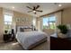 Comfortable main bedroom with a ceiling fan, large window, and neutral decor at 17656 W Bajada Rd, Surprise, AZ 85387