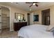 Spacious main bedroom with a dresser, carpeted floor, and ensuite bathroom at 17656 W Bajada Rd, Surprise, AZ 85387