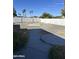 Wide backyard with gravel landscaping, tall block fence, and partial view of the neighborhood's palm trees at 18828 N 17Th Dr, Phoenix, AZ 85027