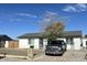 Bright single-story home featuring a large front yard, mature tree, and a welcoming entrance at 18828 N 17Th Dr, Phoenix, AZ 85027