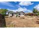 Backyard showing the back of the house with landscaping and a rock feature at 1985 S Plaza Dr, Apache Junction, AZ 85120