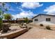 Charming backyard features stone landscaping, brick patio, and privacy fence for outdoor enjoyment at 1985 S Plaza Dr, Apache Junction, AZ 85120