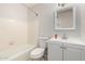 This full bathroom offers a shower and bathtub combo, white vanity, and neutral tile at 1985 S Plaza Dr, Apache Junction, AZ 85120