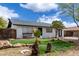 Charming home featuring black and white paint, modern design, desert landscaping, and green grass at 1985 S Plaza Dr, Apache Junction, AZ 85120