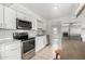 Modern kitchen with stainless steel appliances, white cabinets, and an island with seating at 1985 S Plaza Dr, Apache Junction, AZ 85120