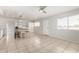 Open-concept living room with tile floors, neutral walls, and views into the kitchen at 1985 S Plaza Dr, Apache Junction, AZ 85120