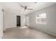 Neutral paint and light wood floors brighten this living room featuring a ceiling fan and outdoor access at 1985 S Plaza Dr, Apache Junction, AZ 85120