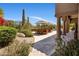 Stunning backyard with lush landscaping, featuring a dining set under umbrellas near the columned patio at 21397 N 78Th St, Scottsdale, AZ 85255