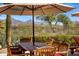 Outdoor dining area with mountain views, perfect for enjoying meals in the serene backyard setting at 21397 N 78Th St, Scottsdale, AZ 85255