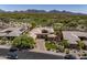 Stunning desert home with lush landscaping, mountain views, and a paver driveway at 21397 N 78Th St, Scottsdale, AZ 85255