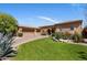Beautiful home exterior features a well-manicured lawn, desert landscaping, and a three-car garage at 21397 N 78Th St, Scottsdale, AZ 85255