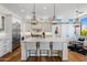 Bright, open kitchen features a marble island, stainless steel appliances, and elegant pendant lighting at 21397 N 78Th St, Scottsdale, AZ 85255