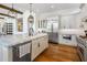 Bright kitchen showcasing a large island, stainless steel refrigerator, and custom white cabinets at 21397 N 78Th St, Scottsdale, AZ 85255