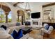 Expansive living room with high ceilings, fireplace, and large windows showcasing the outdoor view at 21397 N 78Th St, Scottsdale, AZ 85255