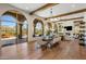 Open-concept living area with hardwood floors, dining table, and seamless access to the outdoor patio at 21397 N 78Th St, Scottsdale, AZ 85255