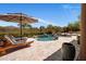 Backyard pool features a rock waterfall, lounge chairs, lush landscaping and views at 21397 N 78Th St, Scottsdale, AZ 85255