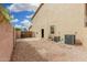 Practical backyard with gravel, utility access and block wall providing privacy at 2143 N Chestnut Cir, Mesa, AZ 85213