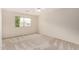 Cozy bedroom with a ceiling fan, neutral carpet, and a bright window at 2143 N Chestnut Cir, Mesa, AZ 85213