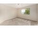 Bedroom with a large window offering great natural light, complemented by neutral carpet at 2143 N Chestnut Cir, Mesa, AZ 85213