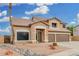 Two-story home showcasing a 3-car garage and a stone accented entryway at 2143 N Chestnut Cir, Mesa, AZ 85213