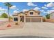 Two-story home with a three-car garage and desert landscaping at 2143 N Chestnut Cir, Mesa, AZ 85213