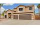 Two-story home showcasing a 3-car garage and a stone accented entryway at 2143 N Chestnut Cir, Mesa, AZ 85213