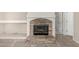 Close up of a stone fireplace with an arch and a neutral hearth at 2143 N Chestnut Cir, Mesa, AZ 85213