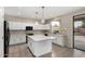 Stylish kitchen with white cabinets, island seating, and modern fixtures at 2143 N Chestnut Cir, Mesa, AZ 85213
