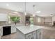 Contemporary kitchen featuring a center island, stainless sink, and granite counters at 2143 N Chestnut Cir, Mesa, AZ 85213