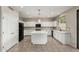 Bright kitchen featuring white cabinetry, island, and stainless steel appliances at 2143 N Chestnut Cir, Mesa, AZ 85213
