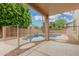 Charming view from the covered patio overlooking the sparkling pool, complete with a secure fence for safety at 2143 N Chestnut Cir, Mesa, AZ 85213