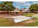 Community basketball court surrounded by greenery, trees and lawn at 2167 S Luther Ave, Mesa, AZ 85209