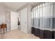 Bathroom featuring white-gray shower curtain and neutral tile flooring at 2167 S Luther Ave, Mesa, AZ 85209