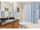 Well-lit bathroom with a shower-tub combo, granite countertops, and wooden cabinets at 2167 S Luther Ave, Mesa, AZ 85209
