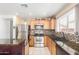 Well-equipped kitchen with stainless steel appliances, mosaic backsplash, and granite countertops at 2167 S Luther Ave, Mesa, AZ 85209