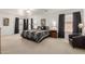 Spacious main bedroom featuring a large bed, side tables, and neutral carpet at 2167 S Luther Ave, Mesa, AZ 85209