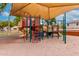 Community playground shaded by a large canopy, surrounded by soft sand at 2167 S Luther Ave, Mesa, AZ 85209
