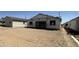 Backyard view of a single Gathering home under construction featuring scaffolding and unfinished roofing at 2356 E Spur Dr, San Tan Valley, AZ 85140