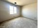 Bedroom featuring large window, smooth grey concrete flooring and grey unfinished walls at 2356 E Spur Dr, San Tan Valley, AZ 85140