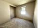 Bedroom featuring walk-in closet, smooth grey concrete flooring and grey unfinished walls at 2356 E Spur Dr, San Tan Valley, AZ 85140